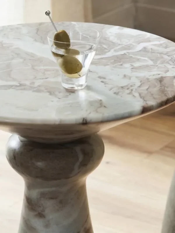 Sculptural Grey Marble Side Table with Fluted Cone Base in ivory — in a room setting