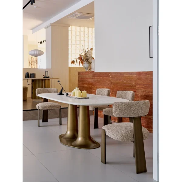 Sculptural Travertine Dining Table in oatmeal — in a room setting