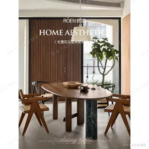 Sengu Marble Dining Table on Asymmetric Wood and Stone Base in ivory — in a room setting