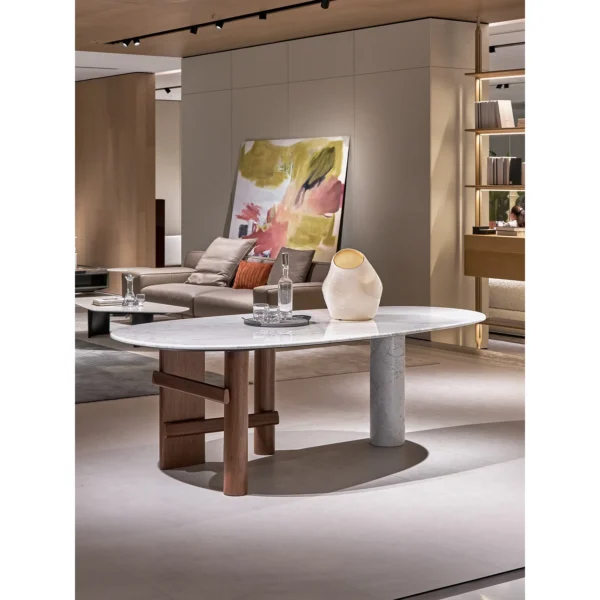 Sengu Marble Dining Table on Asymmetric Wood and Stone Base in ivory — in a room setting