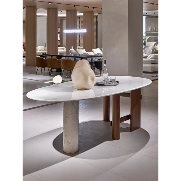 Sengu Marble Dining Table on Asymmetric Wood and Stone Base in ivory — in a room setting