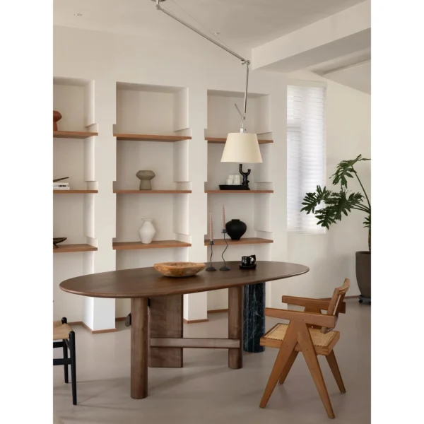 Sengu Marble Dining Table on Asymmetric Wood and Stone Base in ivory — in a room setting