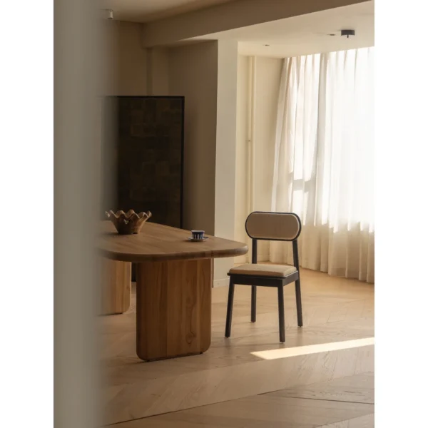 Irwin Black Teak Dining Chair with Cane Seat and Back in black — in a room setting