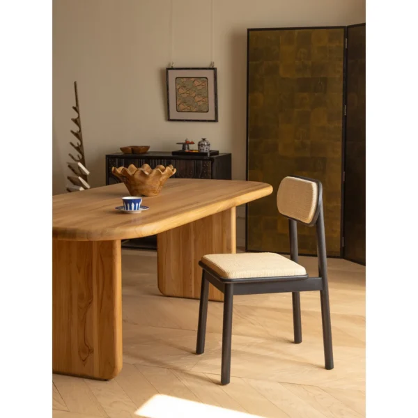 Irwin Black Teak Dining Chair with Cane Seat and Back in black — in a room setting