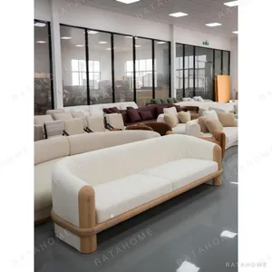 Small-Space Sofa in Cream Wool Linen with Carved Wood Frame — in a room setting