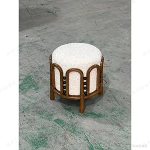 Bent Rattan Low Stool with Cream Bouclé Seat and Beads in clay — in a room setting