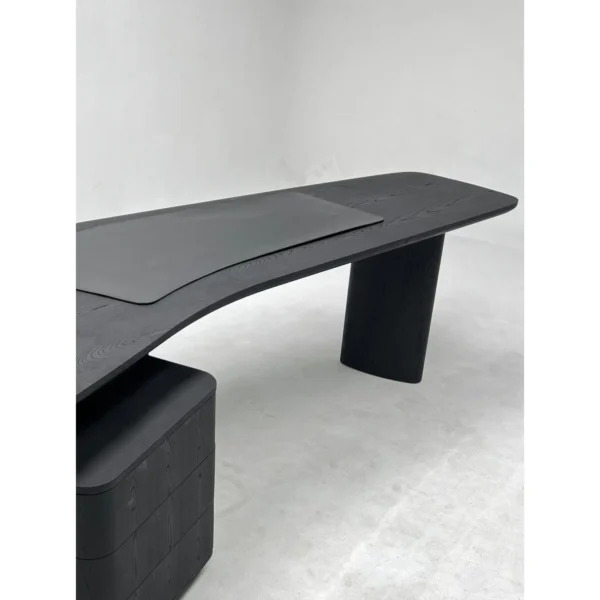 Smoked Black Ash Curved Desk in black — in a room setting