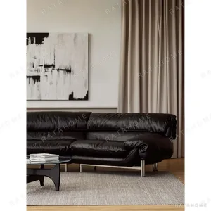 Snow Top Down-Filled Leather Sofa with Eastern Eave Lines in black — in a room setting