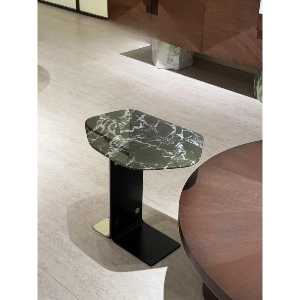 Green Marble Hexagonal Side Table on Black Cantilever Base in olive — in a room setting