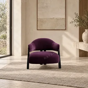 Plum Velvet Curved-Back Armchair on Black Wood Legs in plum — in a room setting
