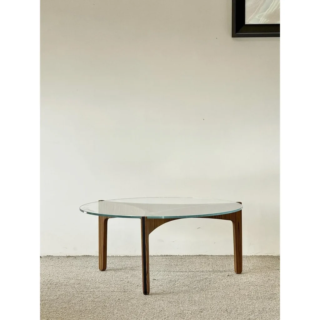 Clear Glass Coffee Table on Walnut Triangular Base in walnut — front view