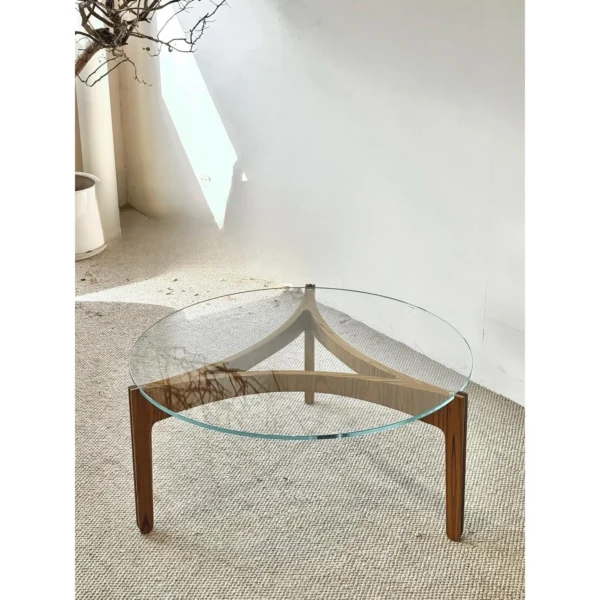 Clear Glass Coffee Table on Walnut Triangular Base in walnut — in a room setting