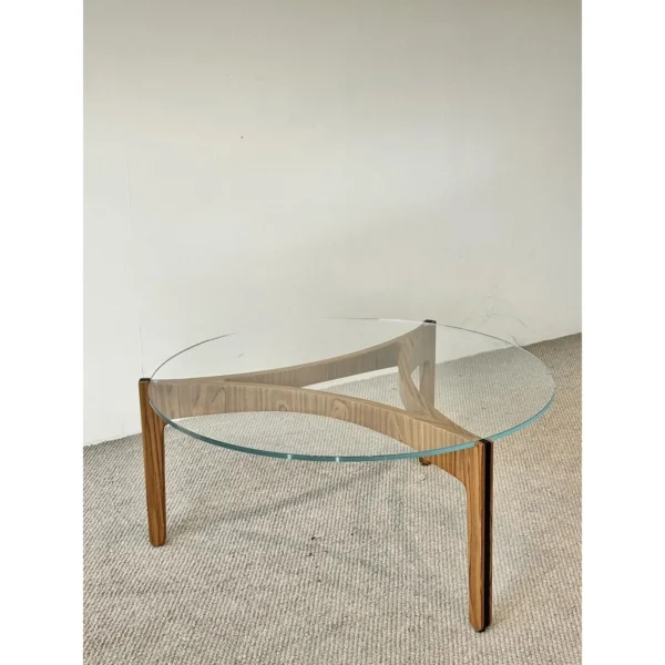 Clear Glass Coffee Table on Walnut Triangular Base in walnut — in a room setting