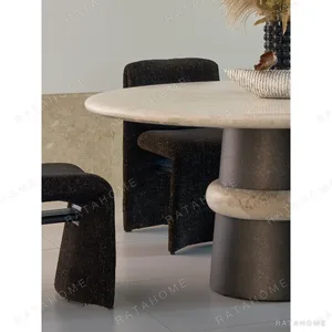 Soft-Light Travertine Round Table in oatmeal — in a room setting