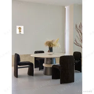 Soft-Light Travertine Round Table in oatmeal — in a room setting