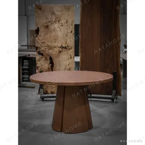 Soft-Line Round Dining Table on Fluted Petal Base in clay — in a room setting