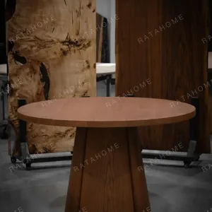 Soft-Line Round Dining Table on Fluted Petal Base in clay — in a room setting