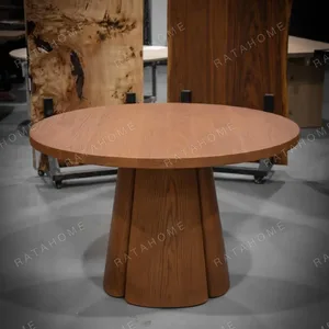 Soft-Line Round Dining Table on Fluted Petal Base in clay — in a room setting