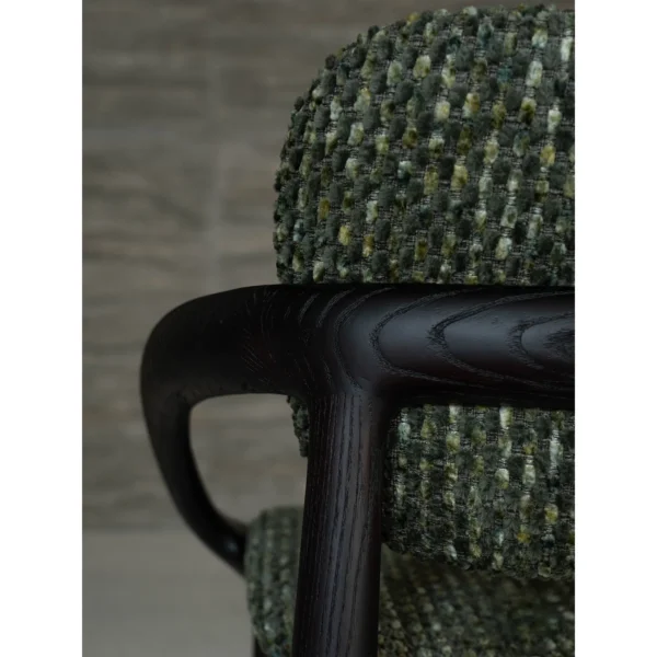 Sculpted Ash Dining Chair with Green Woven Seat in black — in a room setting