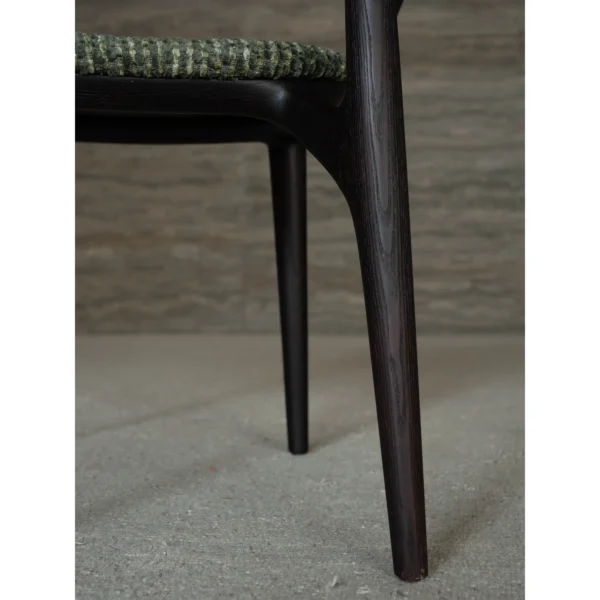 Sculpted Ash Dining Chair with Green Woven Seat in black — in a room setting