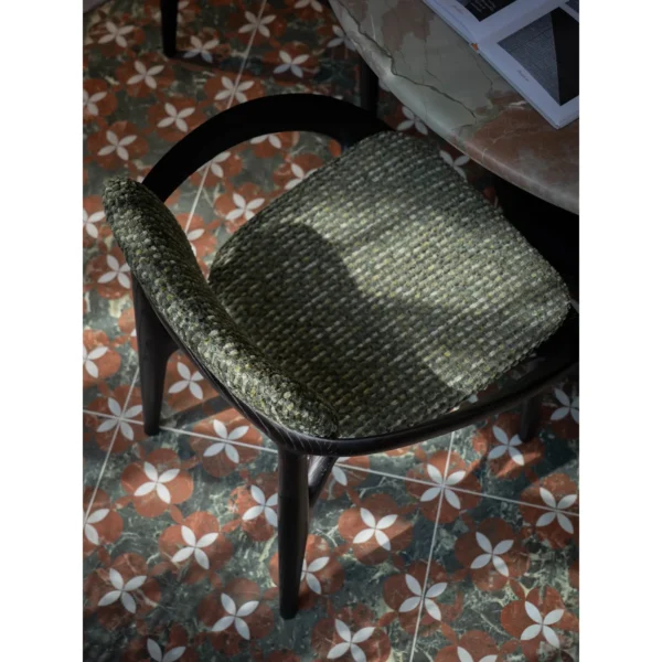 Sculpted Ash Dining Chair with Green Woven Seat in black — in a room setting