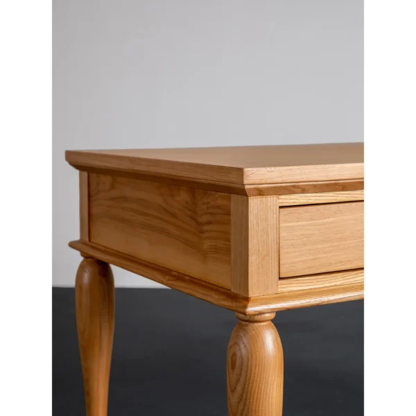 Solid Wood Writing Desk with Turned Legs and Two Drawers in natural oak — in a room setting