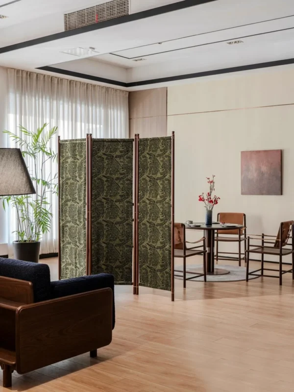 Solid Wood Folding Screen with Patterned Fabric Panels in olive — in a room setting