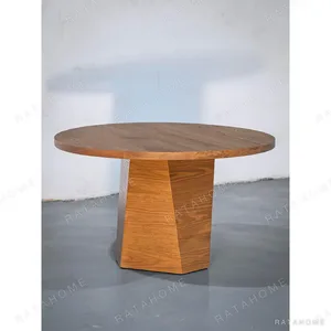 Solid Wood Round Dining Table on Angular Pedestal in clay — in a room setting