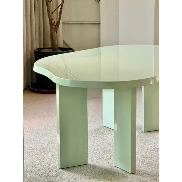 Spring Mist Green Cloud-Shaped Dining Table in olive — in a room setting