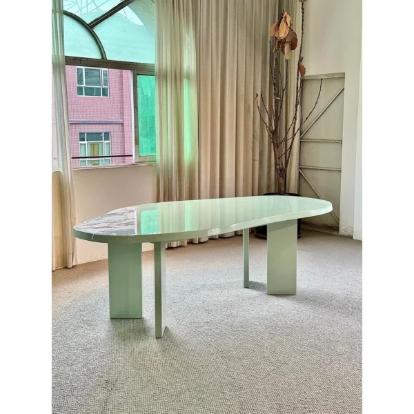 Spring Mist Green Cloud-Shaped Dining Table in olive — in a room setting