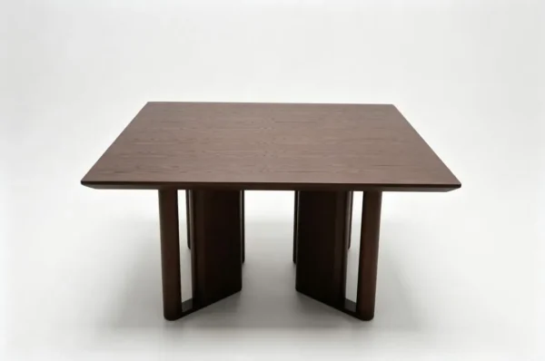 Square Ash Veneer Dining Table on Cross-Panel Base in walnut — in a room setting