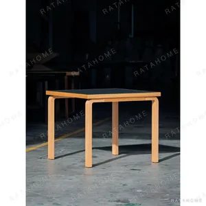 Black-Top Square Dining Table with Bent Oak Legs in black — in a room setting