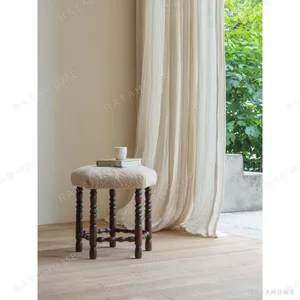 Star Shearling Stool with Turned Dark Wood Legs in oatmeal — in a room setting