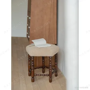 Star Shearling Stool with Turned Dark Wood Legs in oatmeal — in a room setting