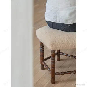 Star Shearling Stool with Turned Dark Wood Legs in oatmeal — in a room setting