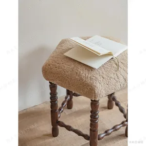 Star Shearling Stool with Turned Dark Wood Legs in oatmeal — in a room setting