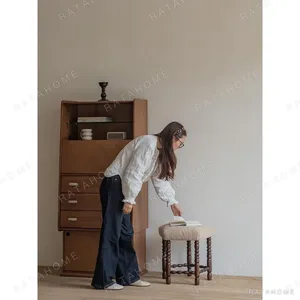 Star Shearling Stool with Turned Dark Wood Legs in oatmeal — in a room setting
