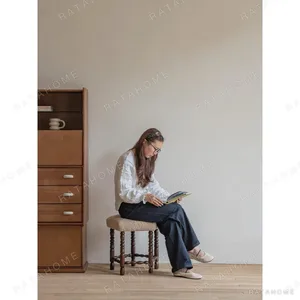 Star Shearling Stool with Turned Dark Wood Legs in oatmeal — in a room setting
