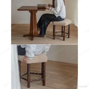 Star Shearling Stool with Turned Dark Wood Legs in oatmeal — in a room setting