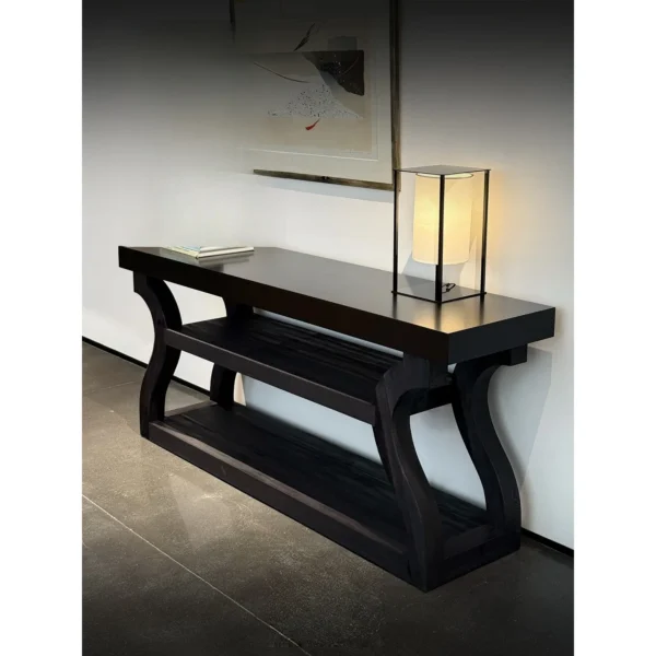 Volu Black Wood Console with Sculpted Side Supports in black — in a room setting