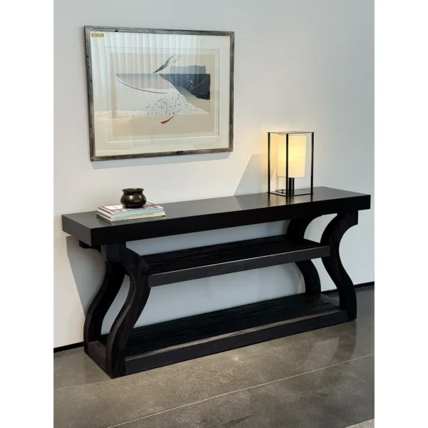 Volu Black Wood Console with Sculpted Side Supports in black — in a room setting