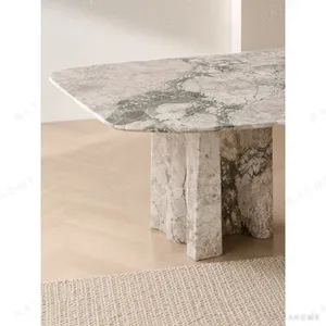 Four Seasons Pink-Green Stone Dining Table on Slab Legs in rose stone — in a room setting