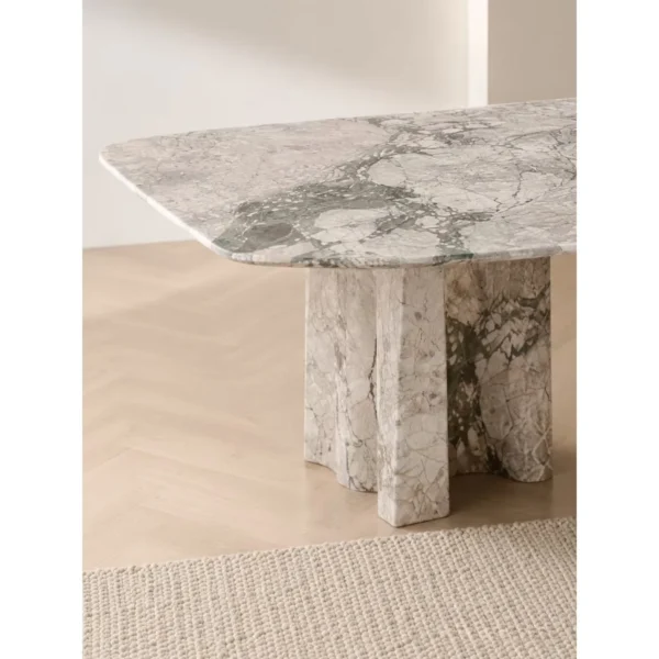 Four Seasons Pink-Green Stone Dining Table on Slab Legs in rose stone — in a room setting
