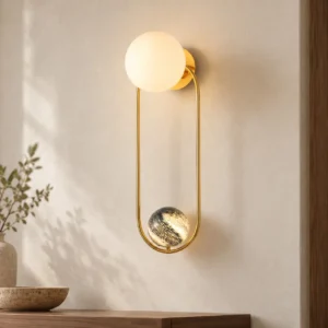 Brass Loop Wall Light with Opal Globe and Marbled Sphere in brushed brass — front view