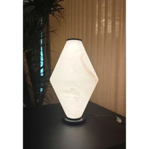 Alabaster-Look Diamond Table Lamp on Black Base in oatmeal — in a room setting