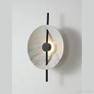 Marbled Stone Disc Wall Light with Black Rod in oatmeal — in a room setting