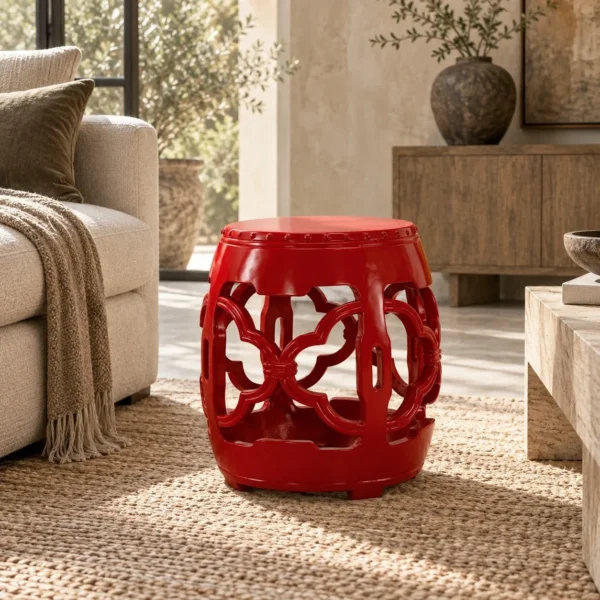 Red Glazed Ceramic Garden Stool with Pierced Cloud Pattern in red — in a room setting