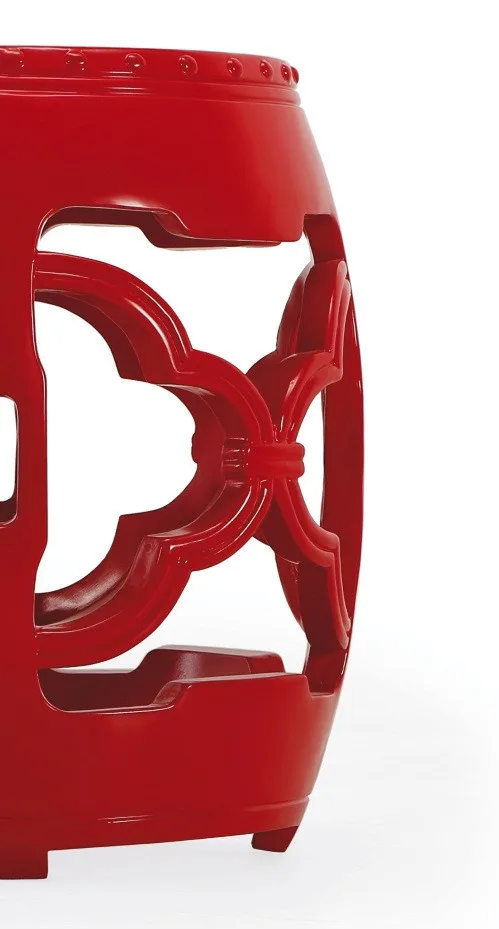 Red Glazed Ceramic Garden Stool with Pierced Cloud Pattern in red — in a room setting
