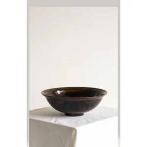 Artist Collaboration Black Glaze Conical Bowl in black — in a room setting