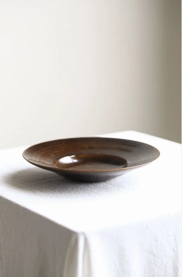 Artist Collaboration Dark Brown Swirl Glazed Ceramic Plate in clay — in a room setting